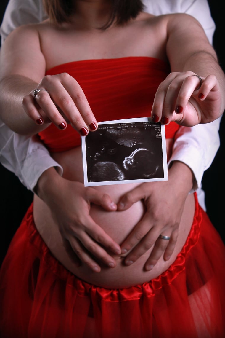 Expectant parents holding an ultrasound image — MCS Equipment supports clinical ultrasound programs